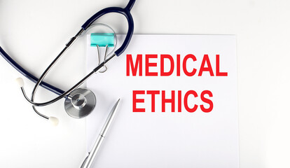 MEDICAL ETHICS text written on the paper with a stethoscope. Medical concept.