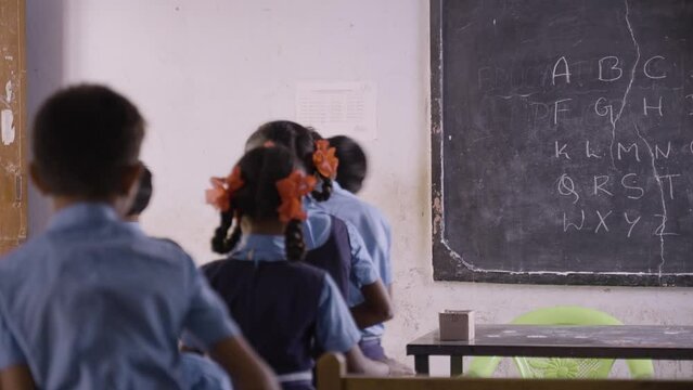 Teacher or instructor going out from classroom after completion of lession at school - conept of happiness, education, learning and knowledge.