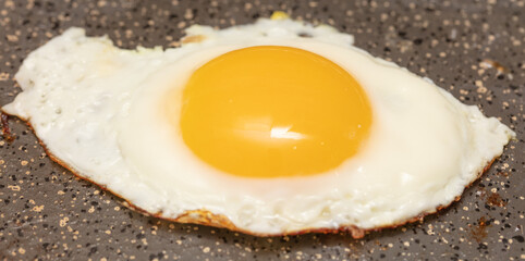 Egg fried in a pan.