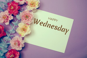 Happy Wednesday typography text and flower decorate on purple background