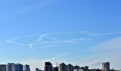 Kyiv, Ukraine - February 26, 2022: War Ukraine Russia. Contrails of an unknown aircraft in the sky over the capital.