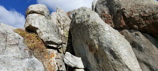 A heap of gray rocks in a national park against a blue sky.
