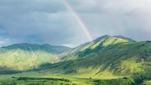 Aerial footage of green mountains and beautiful rainbow nature scenery in Xinjiang, China.