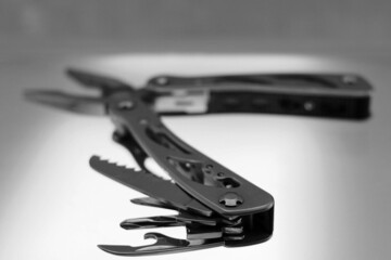 Multitool with blades open and saw