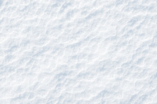 Fresh clean white snow background texture. Winter background with frozen snowflakes and snow mounds. Snow lumps. Seasonal landscape details. Cold weather.