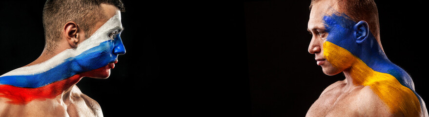 Flag of Russia and Ukraine painted on a face of soldiers. War between Ukraine and Russia