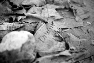 Bad News, newspaper in puddle