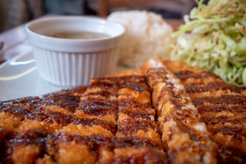 Selective focus view at Lunch menu, Tonkatsu, Deep fried pork with rice, soup and cabbage salad. 