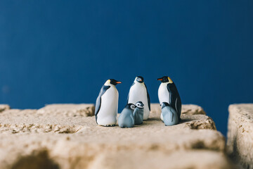 Cute miniature toy penguin colony. Wild animal family. © Yoshi