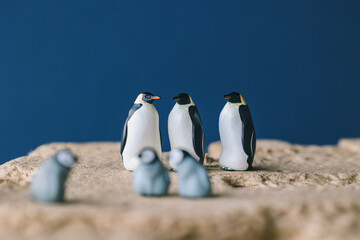 Obraz premium Cute miniature toy penguin colony. Wild animal family.