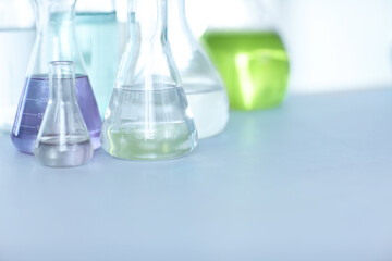 Chemical compounds. Vials filled with colourful liquid on a table in a laboratory.