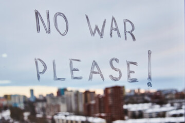 No war please, woman writing on window glass