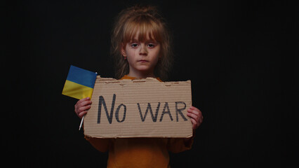 Upset Ukrainian poor toddler girl kid homeless protesting war conflict raises banner with...