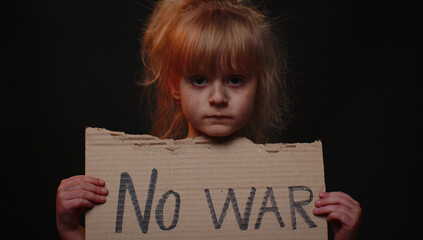 Upset poor toddler girl kid homeless with dirty face protesting war conflict raises banner with...