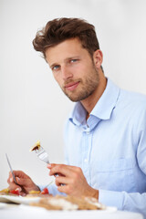 I enjoy well-prepared food. Handsome young man enjoying a meal in a fine restaurant.