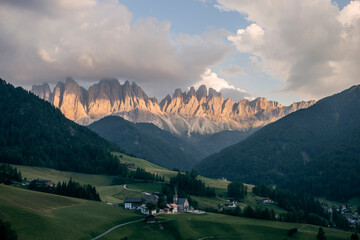 view of funes valley in italy, dolomites, in a summer sunset