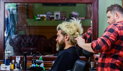 brutal bearded man at hairdresser salon with master, grooming