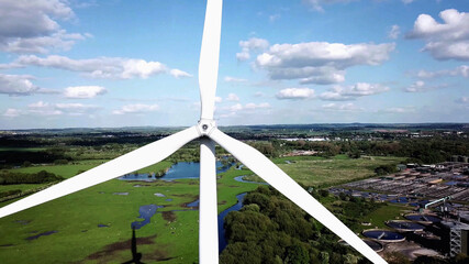 Wind turbine blades in aerial view, agricultural fields and industrial manufacturing background, clean and green Energy Production. - 489544821