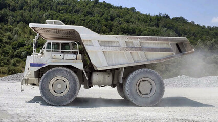 white Haul truck in the quarry, big and large articulated dumping truck, dumper trailer, dump lorry. off-highway heavy-duty construction environment with two axle. - 489544822