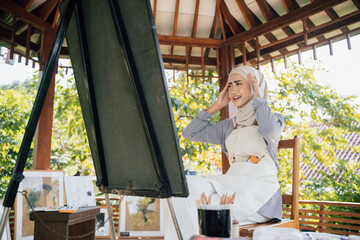 muslim female thinking while working in her project at studio