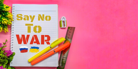 SAY NO TO WAR - text on paper with pink background, peace for Ukraine and Russia.