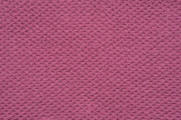 Texture of pink waffle towel. Background of natural waffled cloth from organic linen and cotton.