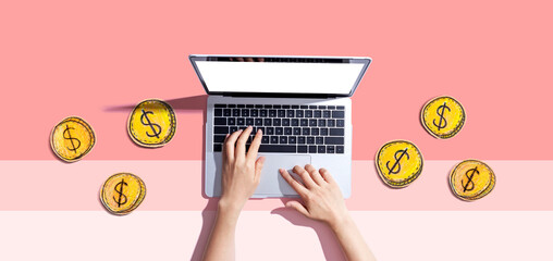 Person using a laptop computer with coins - earn online - work from home themes