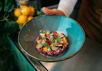 Chef shows the plating of a veggie beet tartar. 