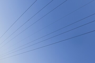 High voltage columns, in the background with blue sky and clouds. Prices of electricity, consumption, ecology.