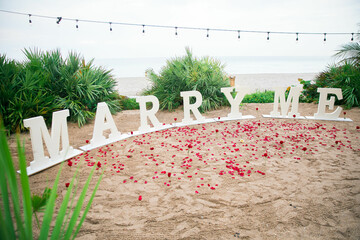 White Proposal letters Marry me outside Sign saying 
