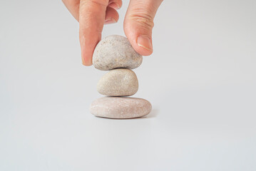 Hand holding pile of white natural stone.Isolated on white background.
your mind, your soul
balancing, begging, meditation concept.