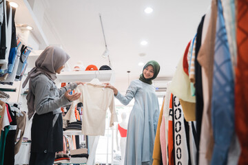 muslim family shopping together at the mall buying some new clothes