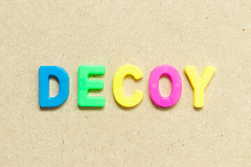 Color alphabet letter with word decoy on wood background