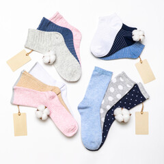 Various modern trendy women's cotton socks set with cotton flowers and price tags on white background. Fashionable socks store. Socks shopping, sale, merchandise, advertisement concept
