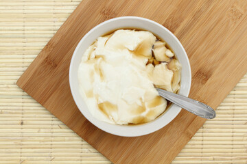 Wedang Tahu or Kembang Tahu, traditional dessert made of soybean pudding with palm sugar and ginger syrup