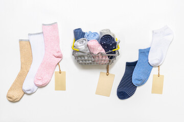 Shopping basket with socks and women's cotton socks set with price tags on white background....
