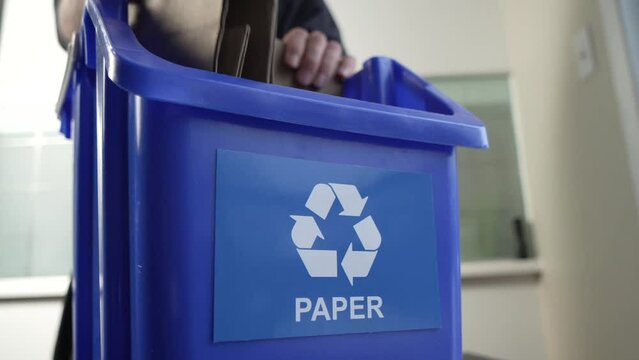 Recycling Paper and Cardboard in a Blue Recycling Bin at Home