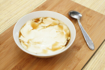 Wedang Tahu or Kembang Tahu, traditional dessert made of soybean pudding with palm sugar and ginger syrup