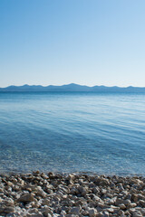Beautiful and calming landscape with pebble beach and clean Adriatic sea, in Zadar, Croatia