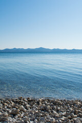 Beautiful and calming landscape with pebble beach and clean Adriatic sea, in Zadar, Croatia
