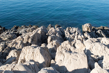 Sharp rocky shore, white limestone by the clean Adriatic sea, in Dalmatia, Croatia