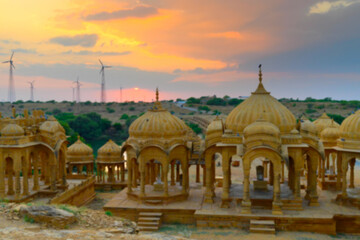 Obraz premium Blurred image of beautiful sunset at Bada Bagh or Barabagh, means Big Garden,is a garden complex in Jaisalmer, Rajasthan, India, Royal cenotaphs for memories of Kings of Jaisalmer state.