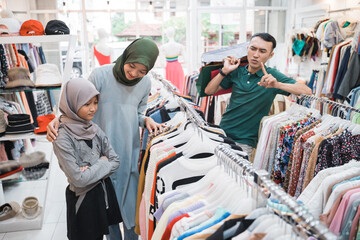unhappy daughter while shopping new clothes with mother
