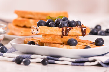 Waffles with blueberries and chocolate cream.