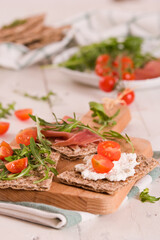 Crispy rye bread with sesame seeds, ham and cottage cheese.
