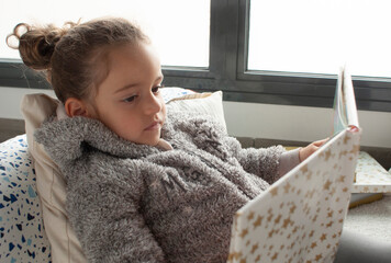 CHILD READING A STORY