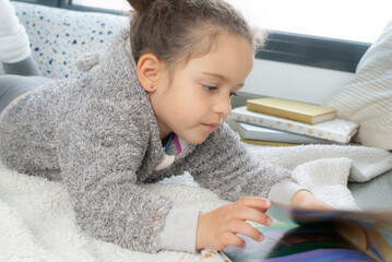 CHILD READING A STORY