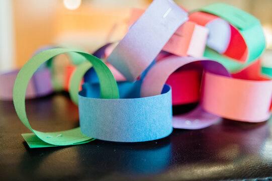 A colorful paper chain on a wooden table