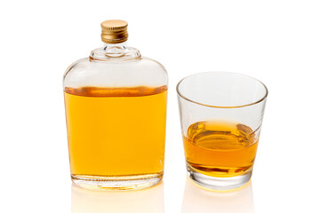 Glass whiskey hip flask, or whisky or bourbon, near a glass of whiskey  isolated on white, clipping path