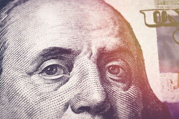 United states hundred dollars money bill, Benjamin Franklin portrait on 100 banknote with sunlight.